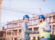 construction labor shortage two workers shaking hands