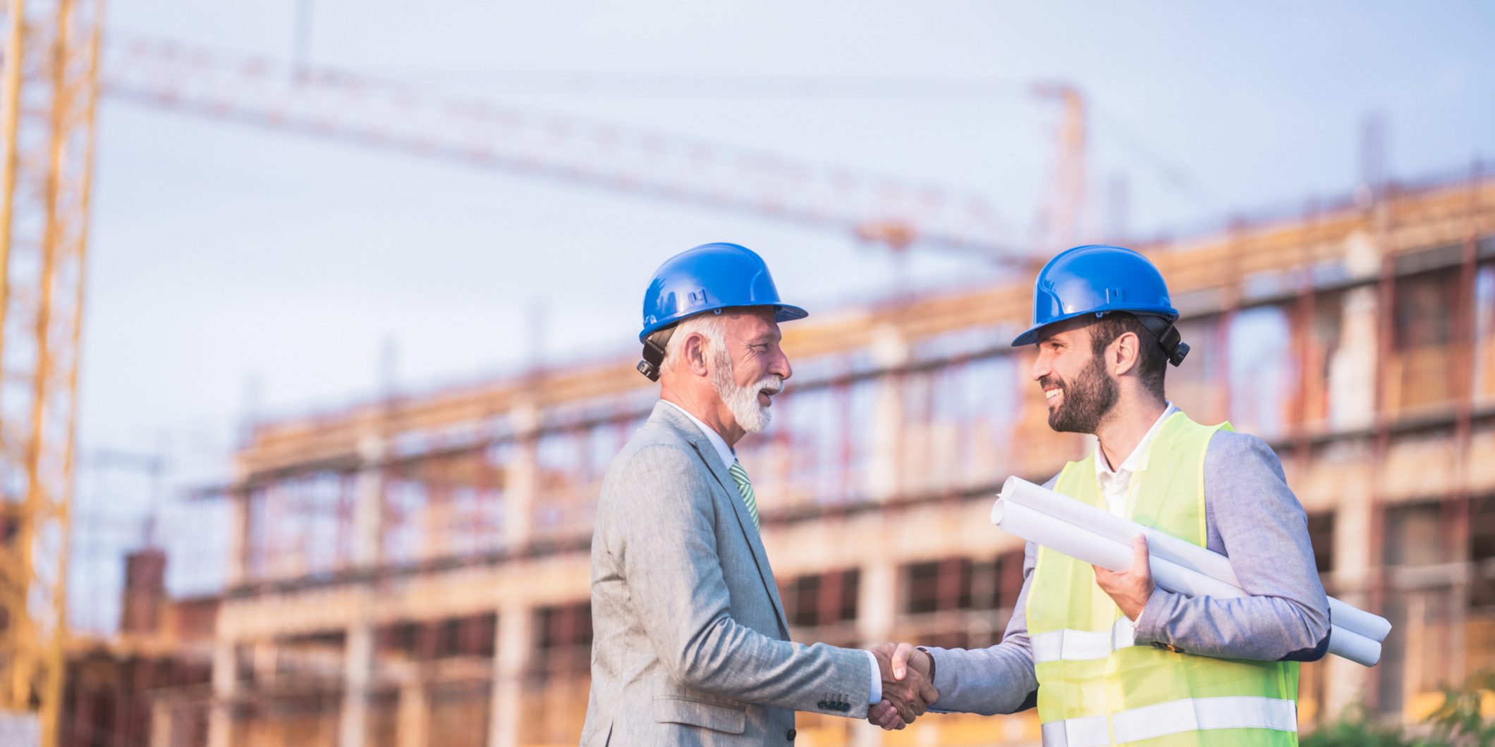 construction labor shortage two workers shaking hands construction labor shortage two workers shaking hands