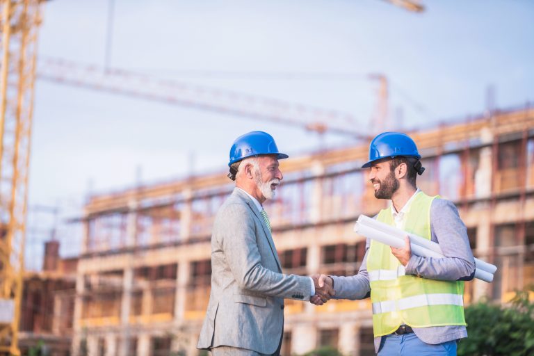 construction labor shortage two workers shaking hands